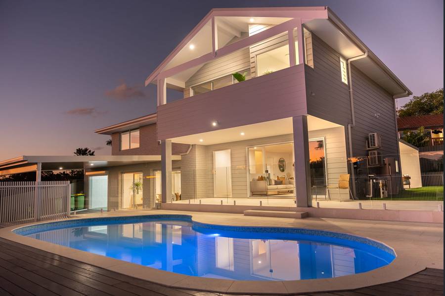 Custom home exterior and pool at dusk